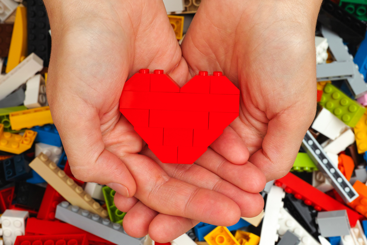 Lego red heart in woman hands